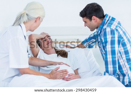Pregnant woman and her husband having a doctor visit in hospital