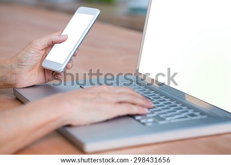 Close up view of hands typing on laptop and texting