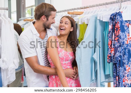 Smiling couple embracing at a boutique