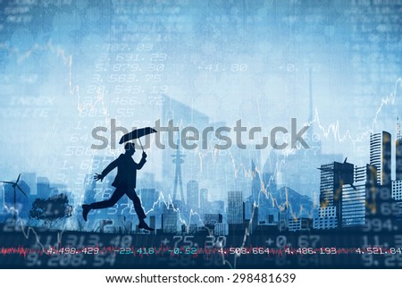 Businessman with umbrella against stocks and shares