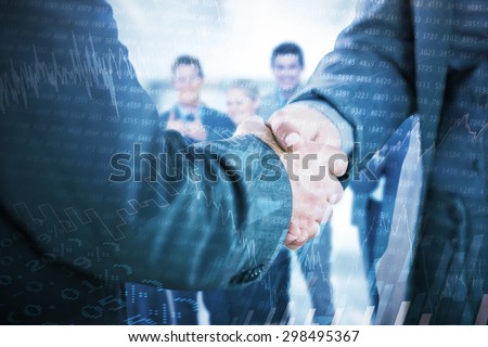 Business people shaking hands close up against stocks and shares