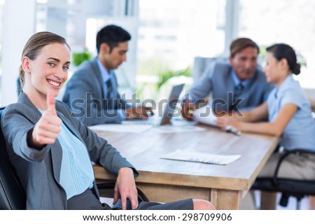 Business people speaking together during meeting in office