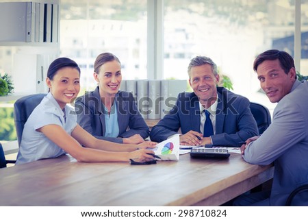 Business people looking at camera during meeting in office