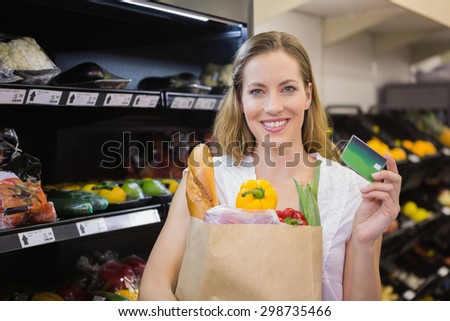 A pretty blonde with a grocery bag in the supermarket