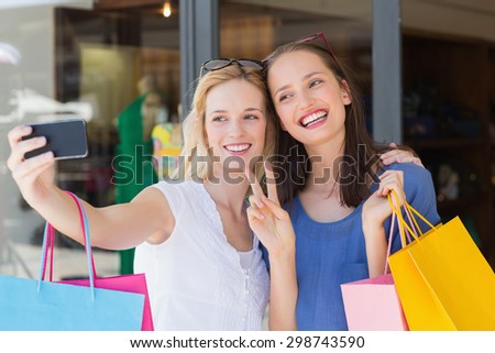 Happy smiling friends taking a selfie with a smartphone