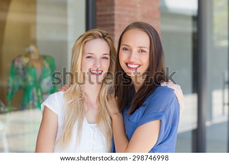 Portrait of smiling friends with arms around