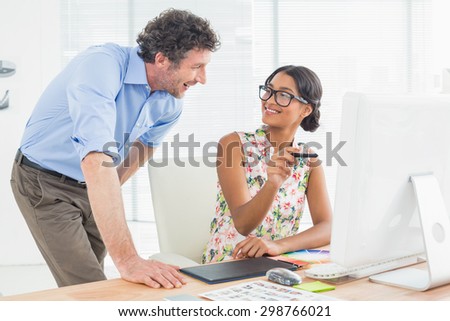 Casual business couple using computer in a bright office