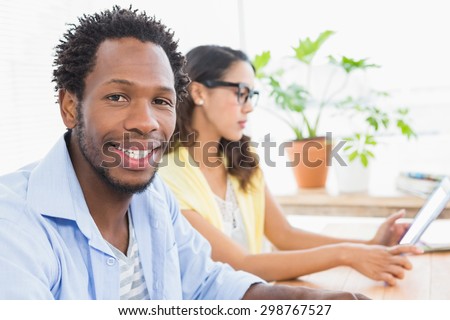 Smiling designer sitting at desk in the office