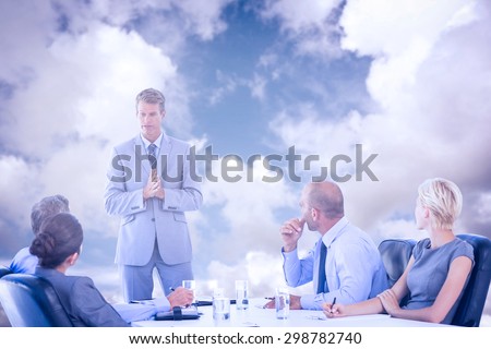 Business people listening during meeting against blue sky with white clouds