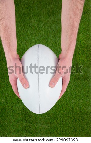 Upward view of a rugby player catching a rugby ball