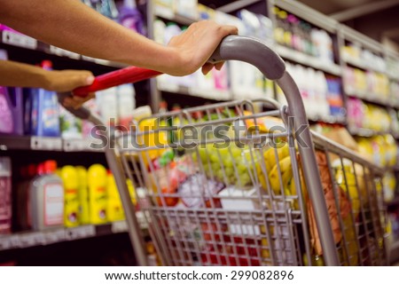 woman buy products with her trolley at supermarket