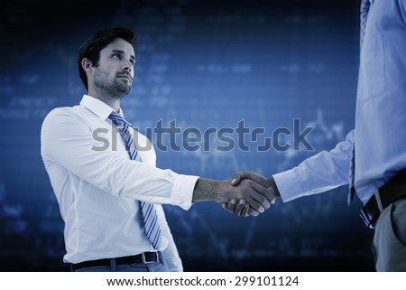 Two businessmen shaking hands in office against stocks and shares