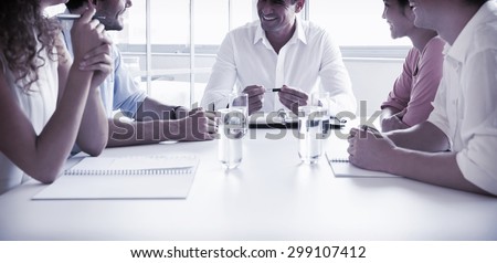 Smiling business people in meeting at conference table in office