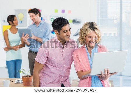 Young creative team people with laptop and digital tablet in office