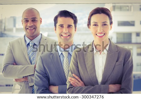 Business colleagues smiling at camera in the office