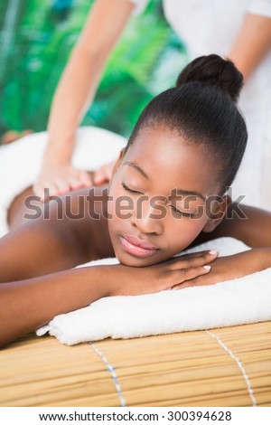 Pretty woman enjoying a back massage at the health spa