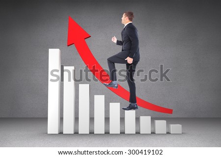 Businessman walking with his leg up against grey room
