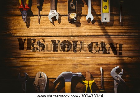 The word yes you can! against desk with tools
