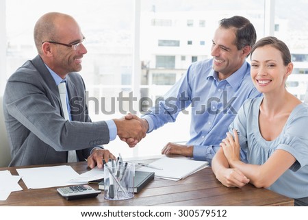 Businessman shaking hands with a co worker in an office