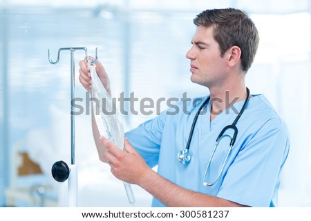 Doctor examining intravenous drip in hospital