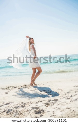 happy woman smiling at the beach on a sunny day