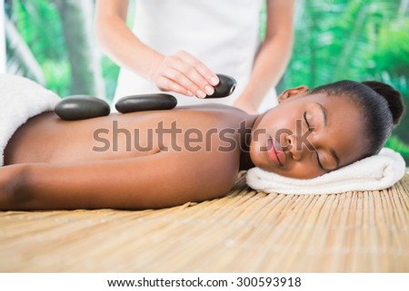 Pretty woman enjoying a hot stone massage at the health spa