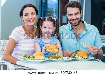 Portrait of a family eating at the restaurant on a sunny day