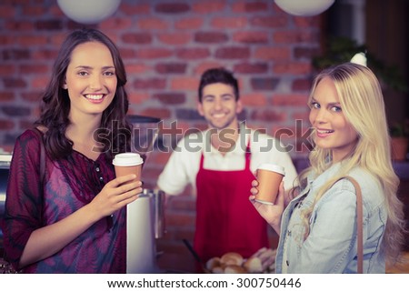 Portrait of a waiter and two customers at the coffee shop