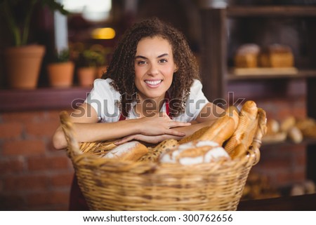 Portrait of a waitress bended over a basket of bread at the coffee shop