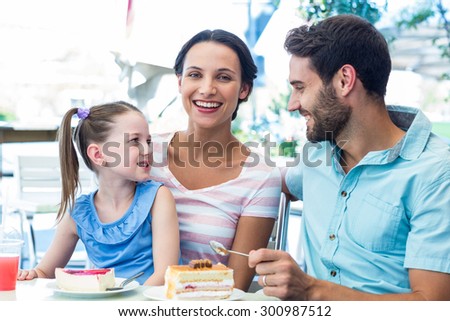 A family eating at the restaurant on a sunny day