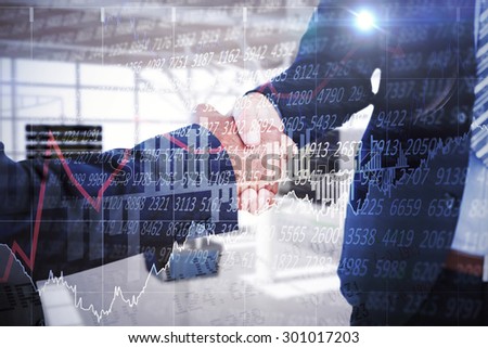 Businessmen shaking hands against stocks and shares