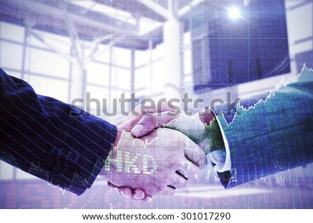 Business people shaking hands against stocks and shares