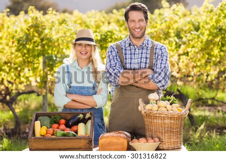 Portrait of a happy farmer couple with arms crossed