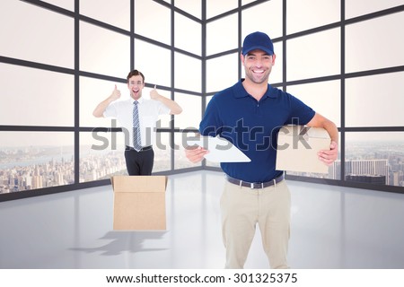 Happy delivery man with cardboard box and clipboard against room with large window showing city