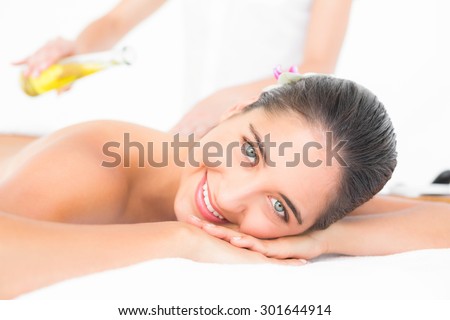 Close up plan of beautiful brunette enjoying an oil massage at the health spa