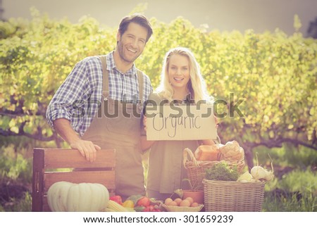 Portrait of happy farmers couple over a table of organic products