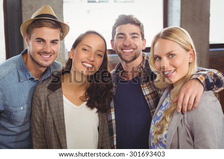 Portrait of happy friends smiling at coffee shop