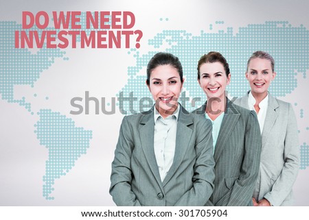 Smiling young businesswomen in a line against green world map on white background