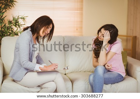 Therapist listening to her patient in therapists office