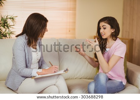 Therapist listening to her patient in therapists office
