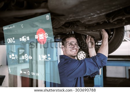 Engineering interface against smiling mechanic adjusting the tire wheel