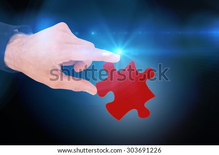 Businessman measuring something with these fingers against blue background with vignette