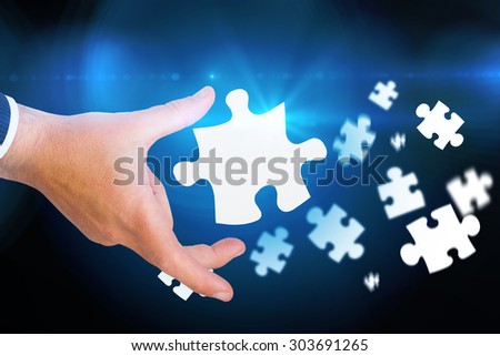 Businessman pointing with his finger against blue background with vignette