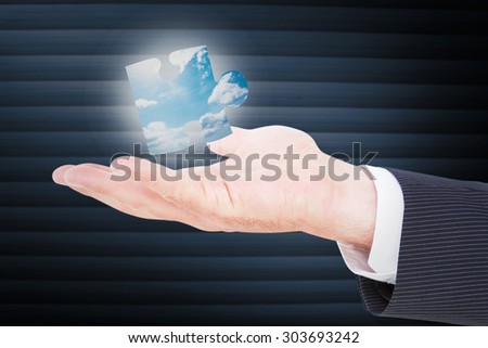 Businessman with wrist watch and hands out against blue sky