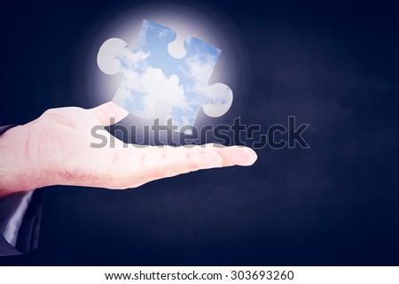 Businessman holding out his hand against blue sky with white clouds