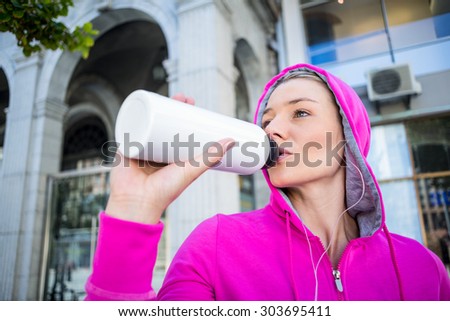A beautiful woman drinking water on a sunny day
