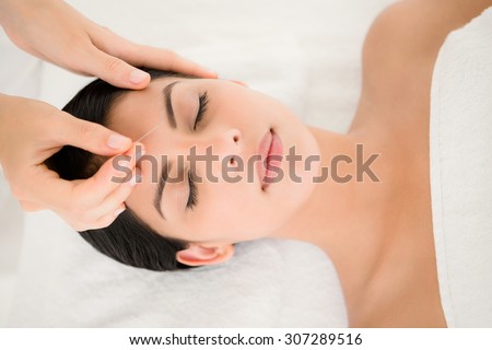 Woman in an acupuncture therapy at the health spa