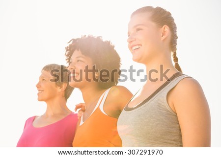 Smiling sporty women looking far away at promenade
