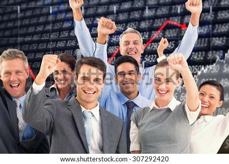 Business people cheering in office against stocks and shares