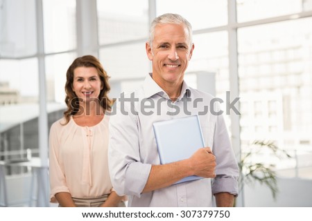 Portrait of casual business colleagues smiling at camera in the office